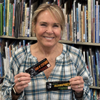 Ann Wilson holding up award-winning bookmarks