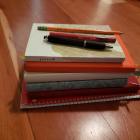 stack of diaries and pens