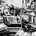 Paula Holding Books, surrounded by books