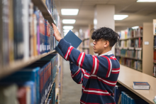 Adrian Marquina studies law books in the Meriam Library