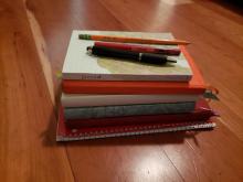 stack of diaries and pens