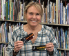 Ann Wilson holding up award-winning bookmarks